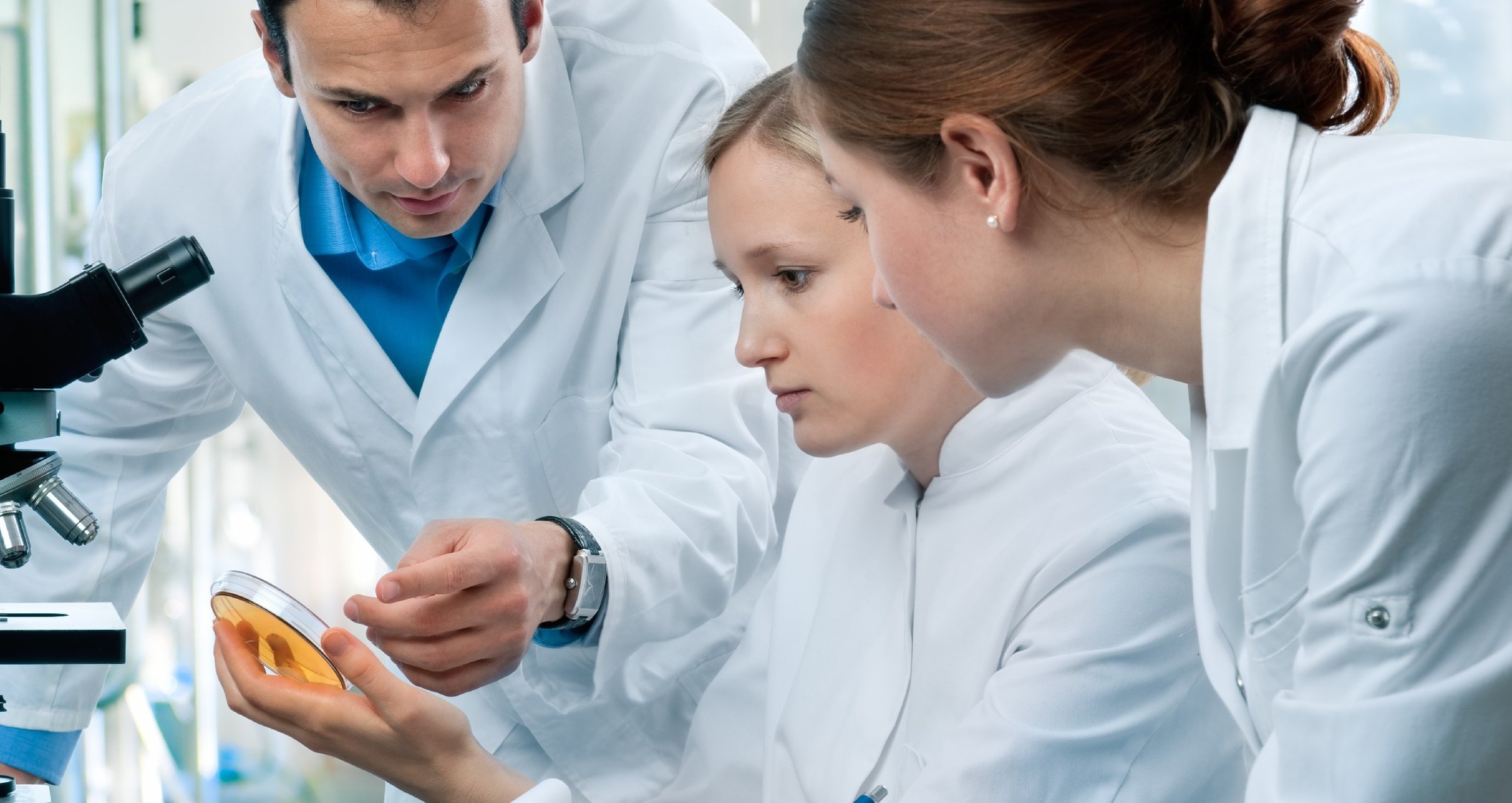 three scientists in lab GettyImages-113173661-1-1