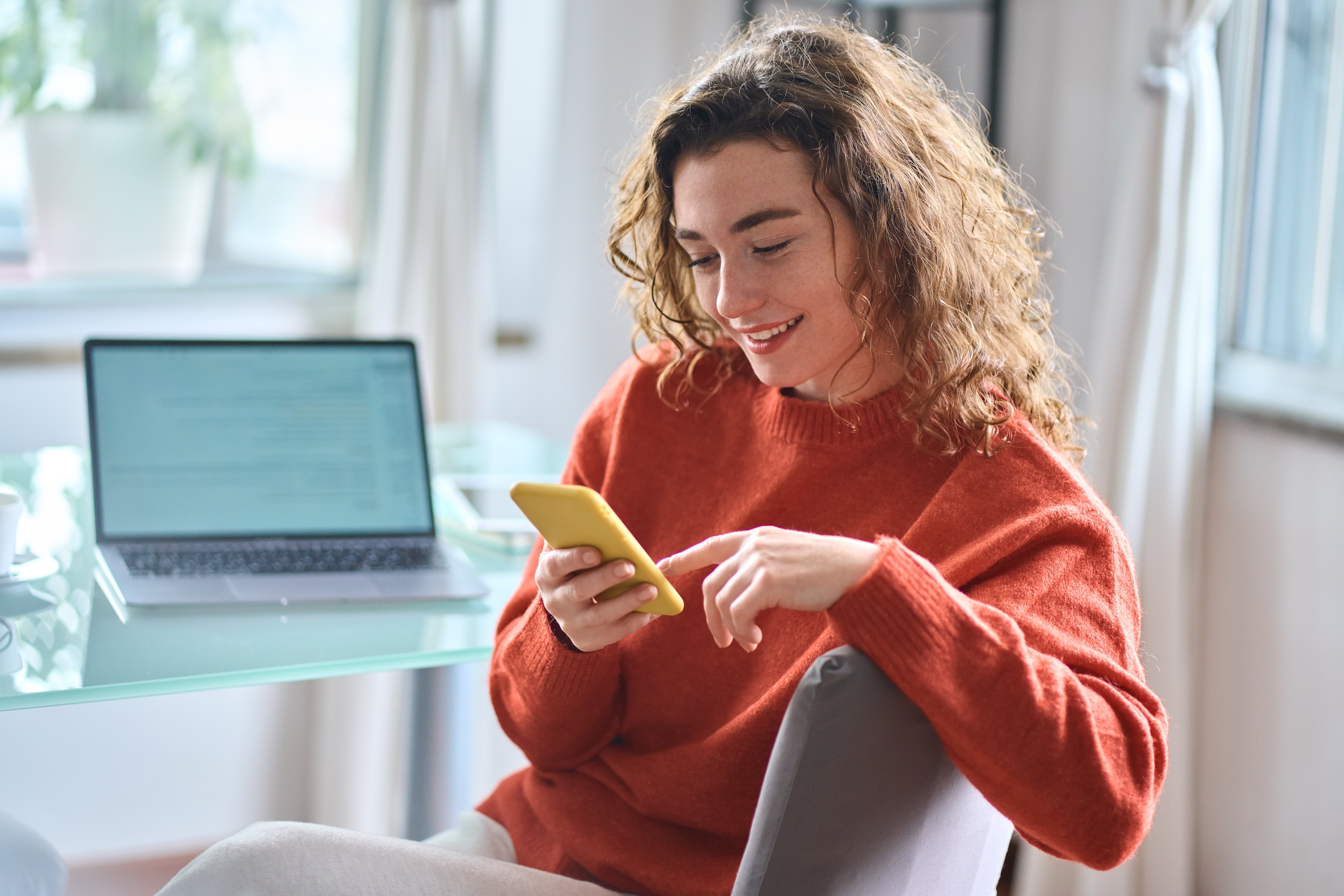 woman researching nonprofit organizations to donate to on her phone